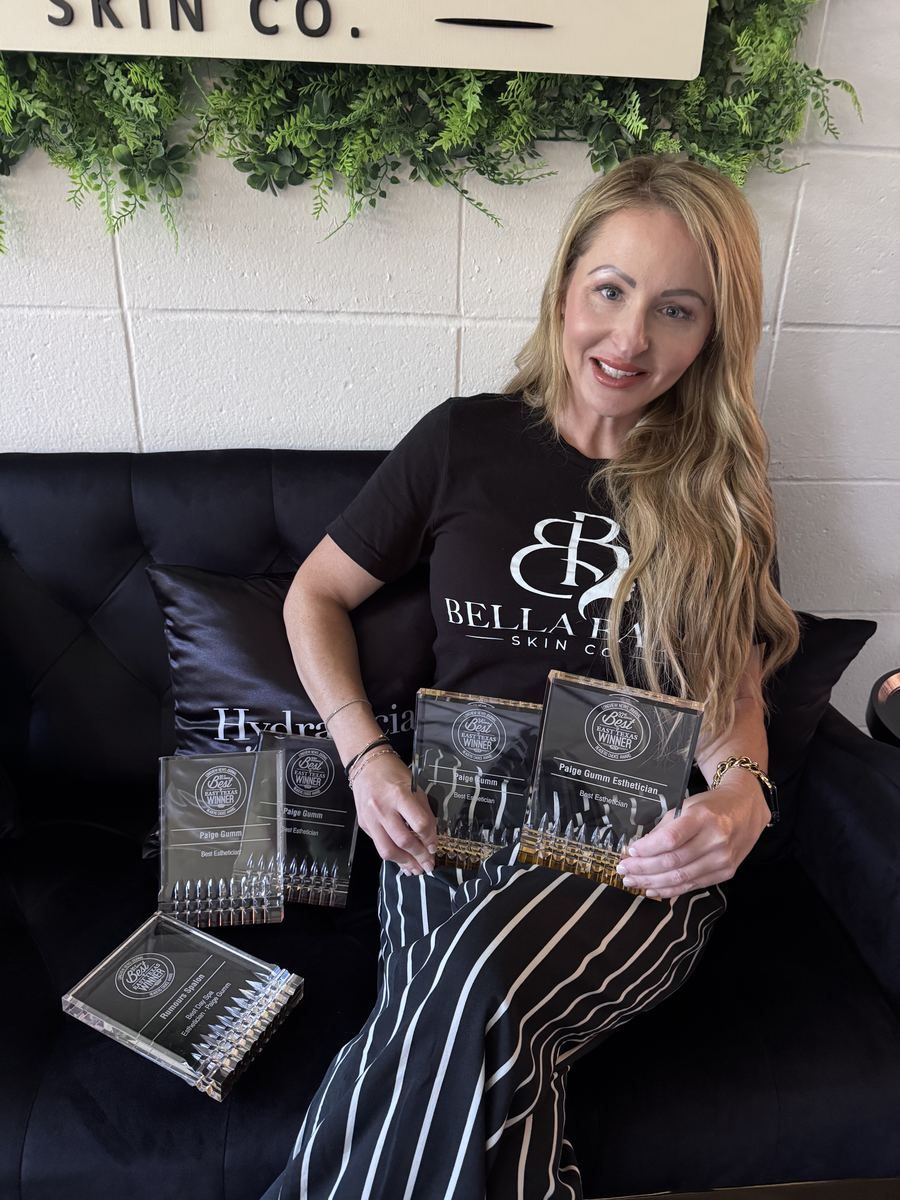 Paige holding her Best of East Texas Best Esthetician awards