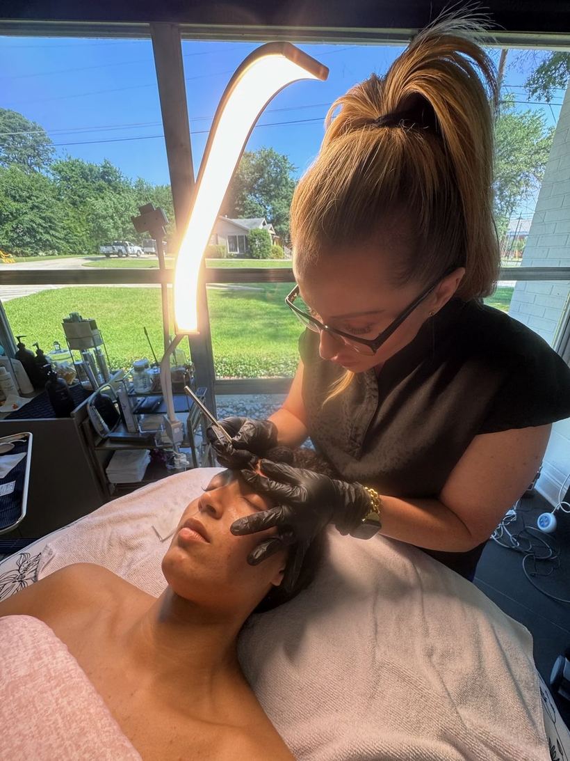 Paige performing a customized facial treatment on a client in her private treatment room